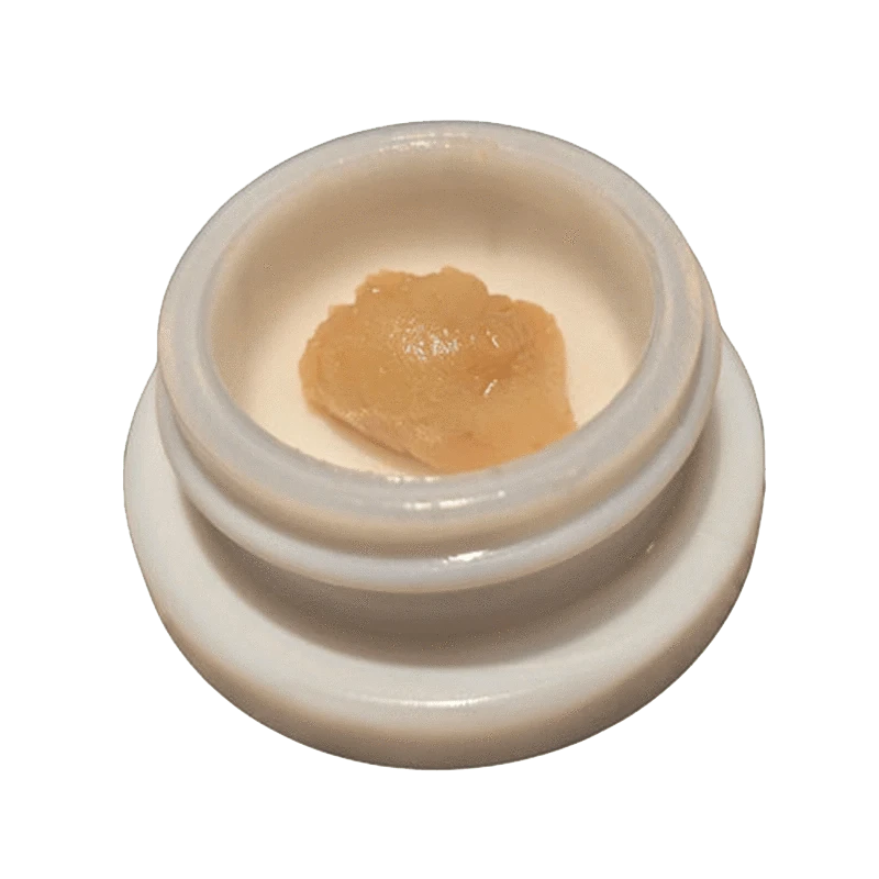 Close-up of Papaya C. Live Rosin with a golden hue, captured in a top-down view against a neutral background.