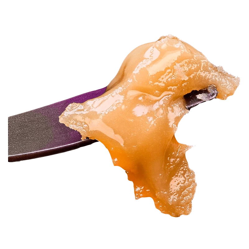 A close-up, angled view of the Live Rosin Seasonal Gas Pack, showcasing its amber color and textured surface.