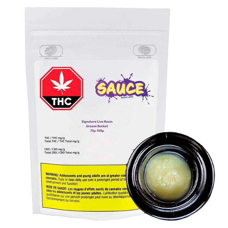 Front view of the Grease Bucket Signature Live Rosin packaging, displaying text and branding details on a dark background.