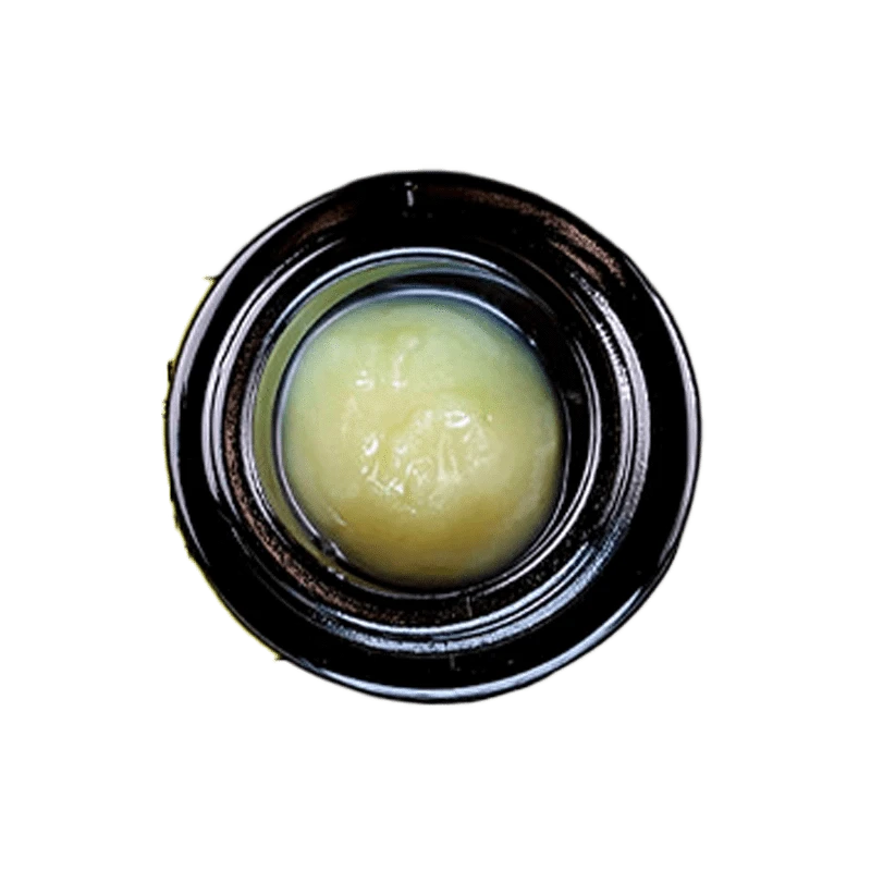 Close-up view of the Grease Bucket Signature Live Rosin, showing a golden, textured substance filling the frame.