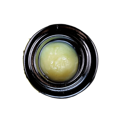 Close-up view of the Grease Bucket Signature Live Rosin, showing a golden, textured substance filling the frame.