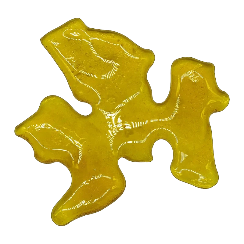 A close-up of the Endgame Slabz Shatter, displaying a golden, translucent material with a unique, flowing shape.