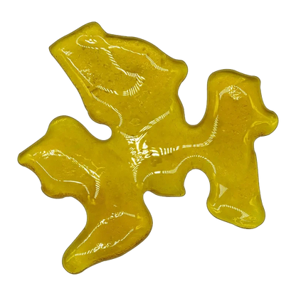 A close-up of the Endgame Slabz Shatter, displaying a golden, translucent material with a unique, flowing shape.
