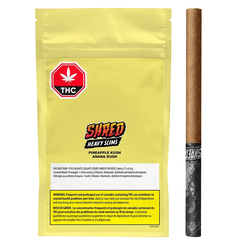 Flat front view of the yellow pouch and slim pre-roll arranged side-by-side, labeled "Pineapple Kush Heavy Slims Infused PR 5 x 0.4 g" with a red THC octagon and bold "SHRED" logo.