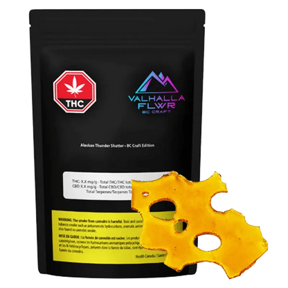Close-up of the Alaskan Thunder Shatter packaging with a bold logo and cannabis leaf against a dark background.