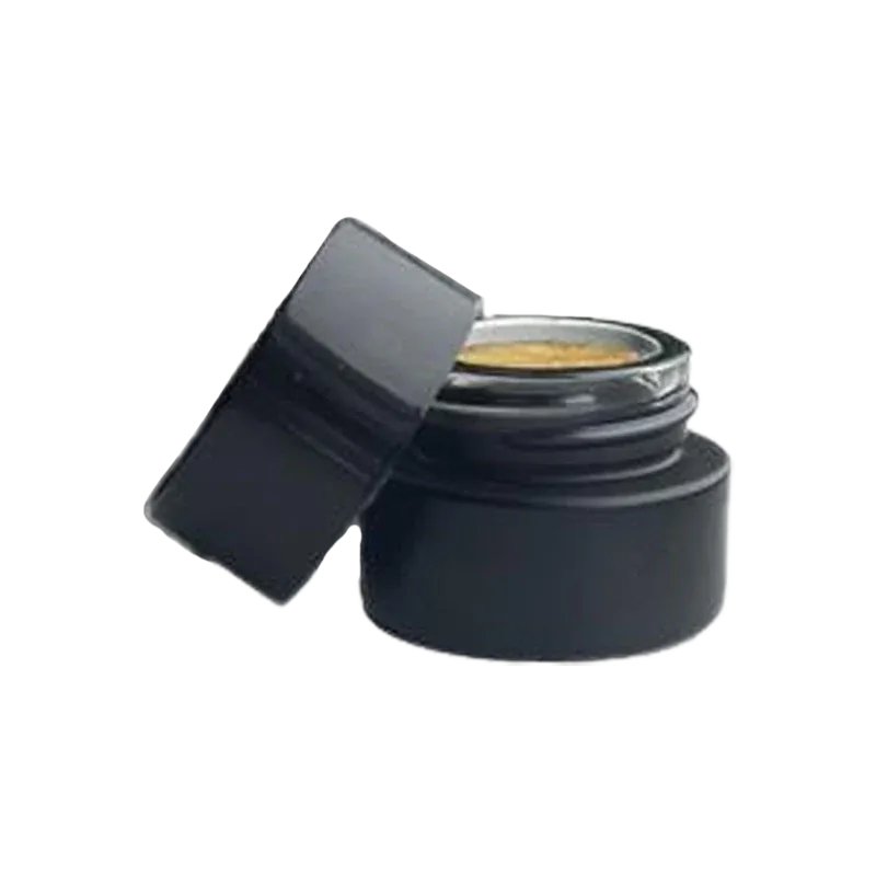 Angled close-up of an open black jar of golden concentrate labeled G.A.S. Rosin, lid resting against the side.