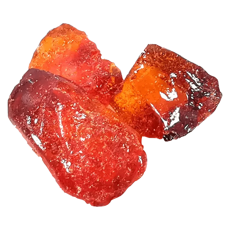Close-up of three glossy red-orange resin chunks on a white background, shown as Fractals Full Cannabinoid Spectrum Diamond.