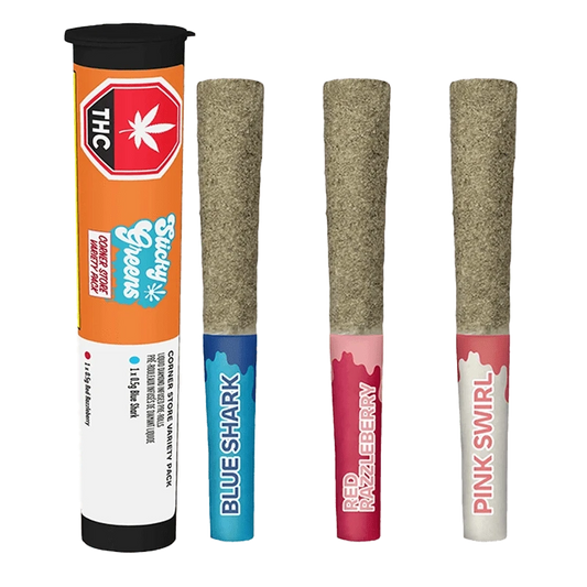 Straight-on view of three kief-coated pre-rolls labeled Blue Shark, Red Razzleberry and Pink Swirl beside an orange tube of Corner Store Kief Coated Liquid Diamond Infused PR 3 x 0.5 g.