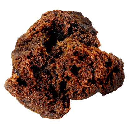 Close-up of a crumbly dark brown chunk of Afghan Black Hash shown against a transparent background, highlighting its porous texture.