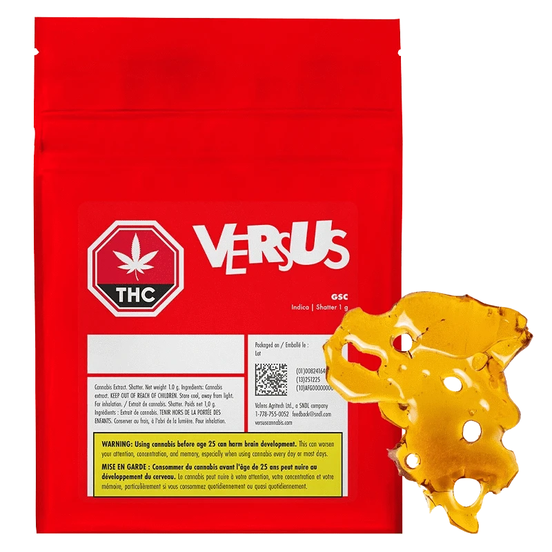 Front view of the red VERSUS GSC Shatter pouch with a golden amber slab of shatter placed overlapping its lower right corner.