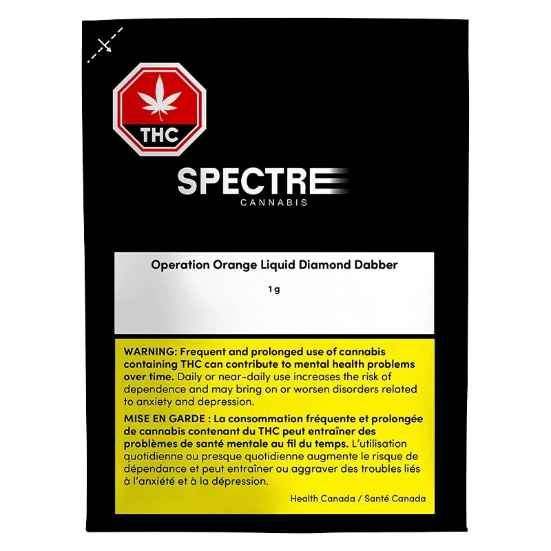 Front-facing shot of the Spectre Cannabis Operation Orange Liquid Diamond Dabber packaging against a black background, showing the white product label and yellow health warning.
