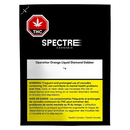 Front-facing shot of the Spectre Cannabis Operation Orange Liquid Diamond Dabber packaging against a black background, showing the white product label and yellow health warning.