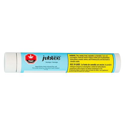Horizontal product shot of the light-blue tube labeled Nostalgia - Aged Sticky Hash Infused PR 1 x 1 g with Jubilee branding and a yellow warning panel.