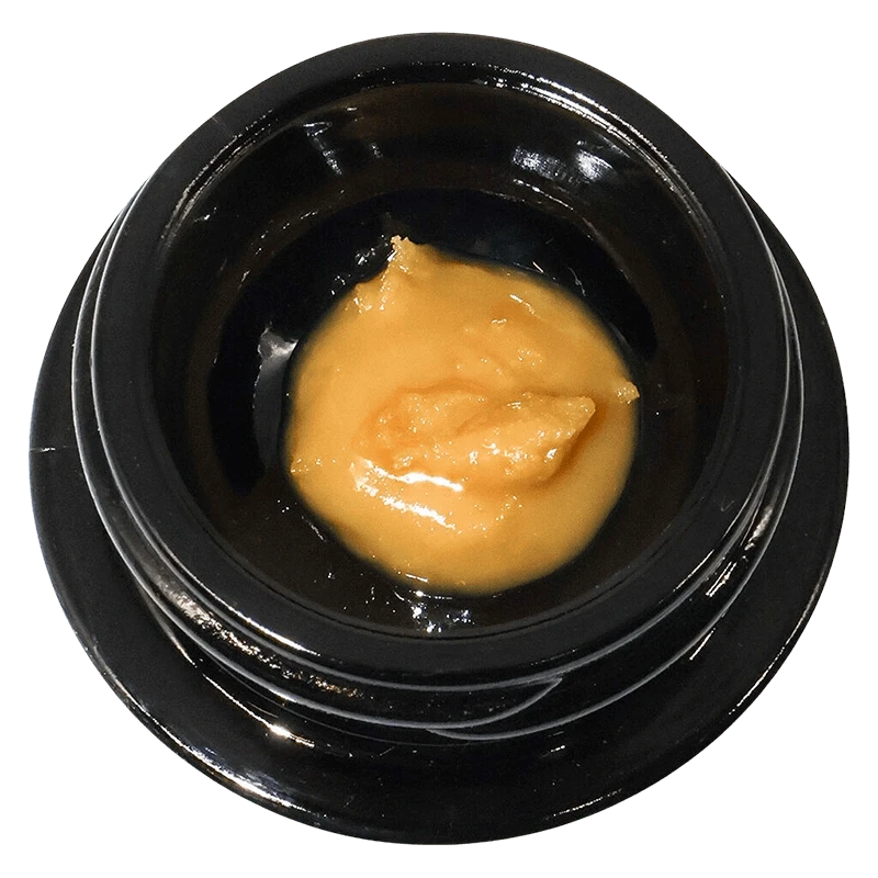 Top-down view of a small black jar holding a glossy dollop of golden concentrate labeled Mochazilla Live Rosin.
