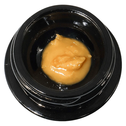 Top-down view of a small black jar holding a glossy dollop of golden concentrate labeled Mochazilla Live Rosin.