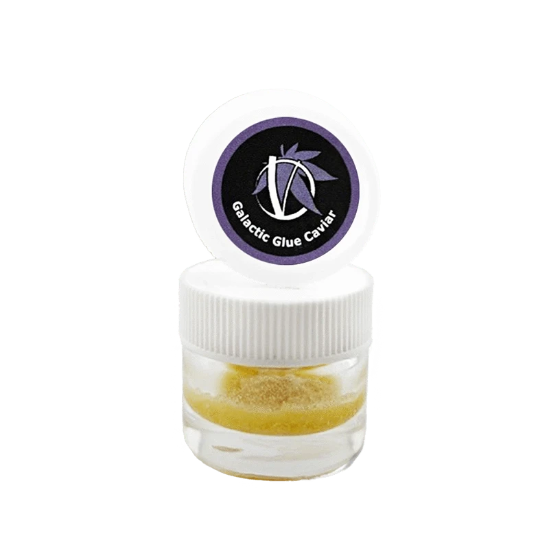 Centered front view of a small clear jar with white lid and purple logo reading Galactic Glue Caviar, showing a golden granular concentrate inside.