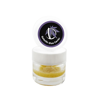Centered front view of a small clear jar with white lid and purple logo reading Galactic Glue Caviar, showing a golden granular concentrate inside.
