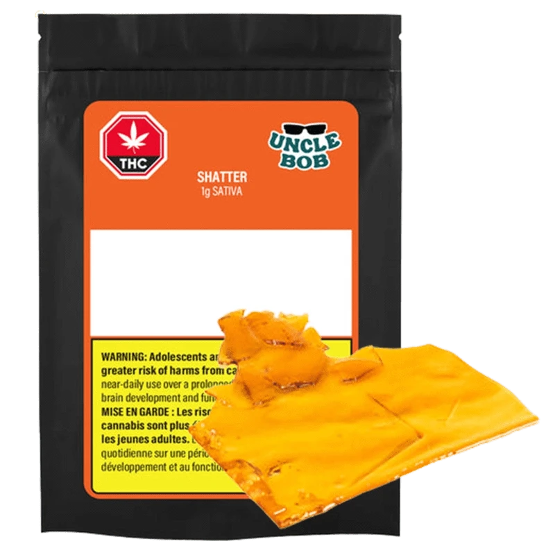 Front-facing shot of the Uncle Bob Sativa Shatter 1 g pouch with bright orange label and amber translucent shatter pieces overlapping the package.