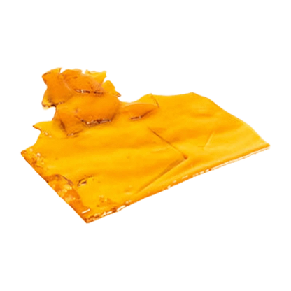 Close-up, angled view of a glossy amber slab of Sativa Shatter resting on a white background.