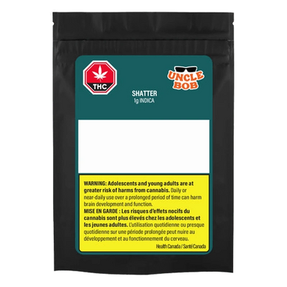 Front-facing black pouch labeled "Uncle Bob Indica Shatter" with teal header, empty white info panel and a yellow bilingual health warning block.