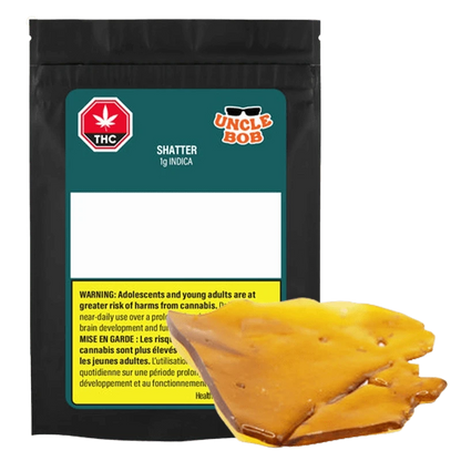 Front view of the Uncle Bob Indica Shatter 1 g package with a glossy amber-colored shatter piece resting in front.