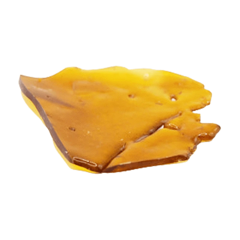 Close-up top-down view of a glossy amber shard of Indica Shatter resting on a white background.