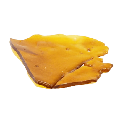 Close-up top-down view of a glossy amber shard of Indica Shatter resting on a white background.