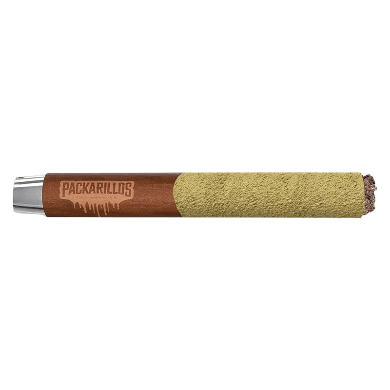 Side-on studio shot of a Packarillos Purple Zaza Infused PR 1 x 1 g blunt showing the brown branded paper and a heavy greenish kief coating on the rolled end.