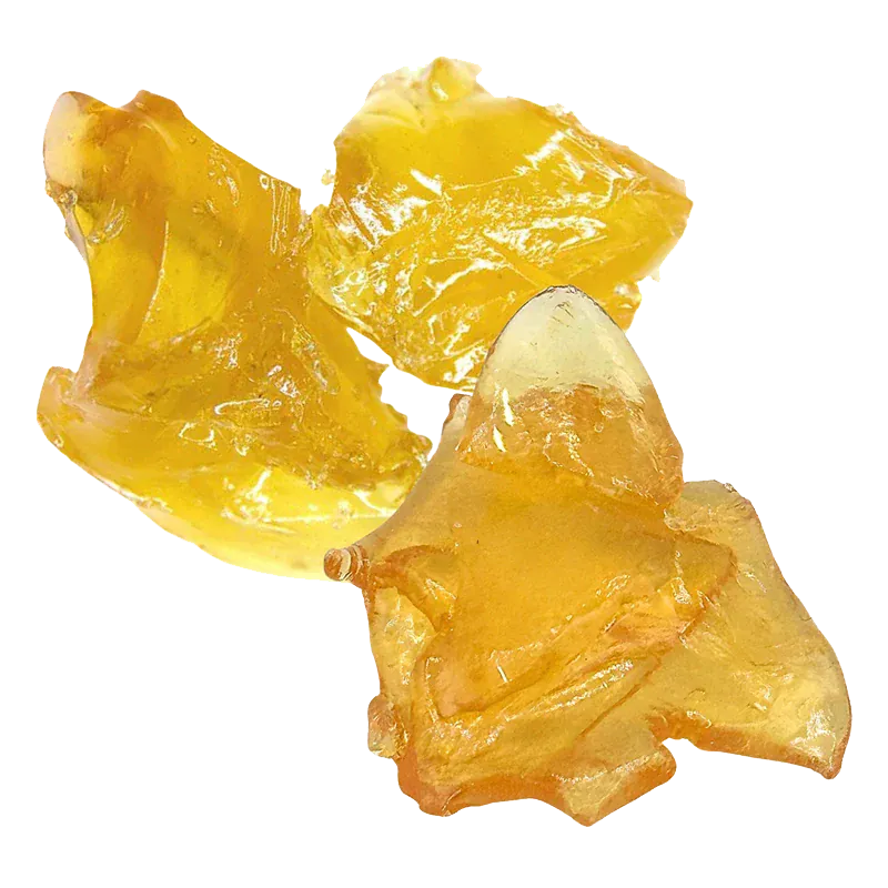 Close-up of three glossy amber shards of Orange Creamsicle Shatter shown on a white background, highlighting their translucent, irregular textures.