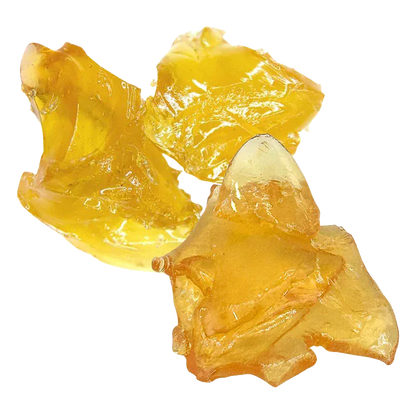 Close-up of three glossy amber shards of Orange Creamsicle Shatter shown on a white background, highlighting their translucent, irregular textures.