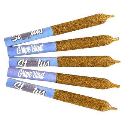 Angled top-down view of five Grape Blast Liquid Diamond Infused kief coated PR 5 x 0.25 g pre-rolls with blue grape-branded tips and textured kief coating.