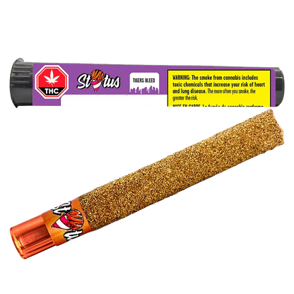 Angled close-up of a glittery, gold kief-coated pre-roll with an orange tip and its purple "Tigers Bleed Liquid Diamond Infused kief coated PR 1 x 1 g" tube shown above.