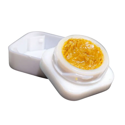 Close-up of an open white container showing golden concentrate inside, labeled Slurricane Jar Live Rosin.