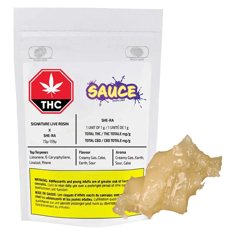 Clear front-facing shot of the Signature Black Maple Live Rosin pouch with a pale, glossy 1 g rosin globule beside it.