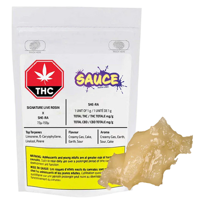 Clear front-facing shot of the Signature Black Maple Live Rosin pouch with a pale, glossy 1 g rosin globule beside it.