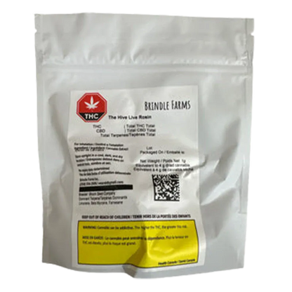Front-facing shot of a white foil pouch labeled "Brindle Farms The Hive Live Rosin" with a red THC symbol and a yellow warning box near the bottom.