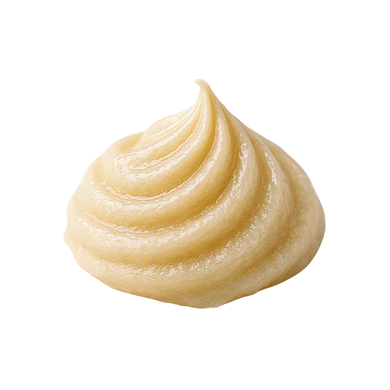 Close-up of a glossy pale yellow cream swirl of Sherbet Queen Live Whipped Diamonds on a white background