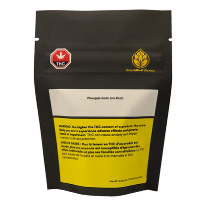 Front view of a black pouch labeled EarthWolf Farms Pineapple Garlic Live Rosin with a white label and yellow THC warning block.