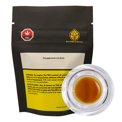 Front view of a black pouch and a clear glass jar showing amber rosin, labeled "Pineapple Garlic Live Rosin" by EarthWolf Farms.