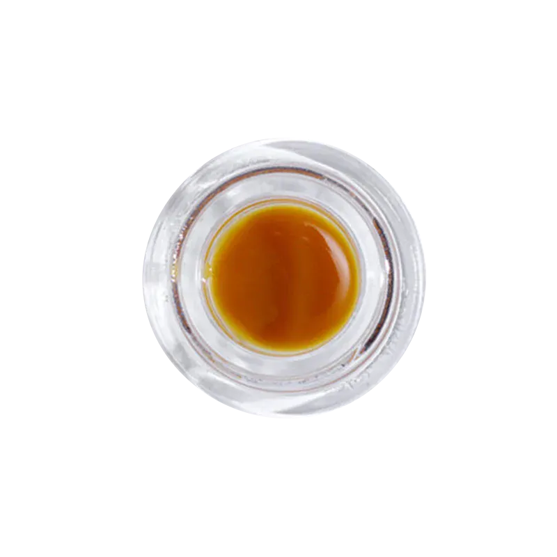 Top-down view of a small glass jar of Pineapple Garlic Live Rosin showing glossy amber concentrate against a white background