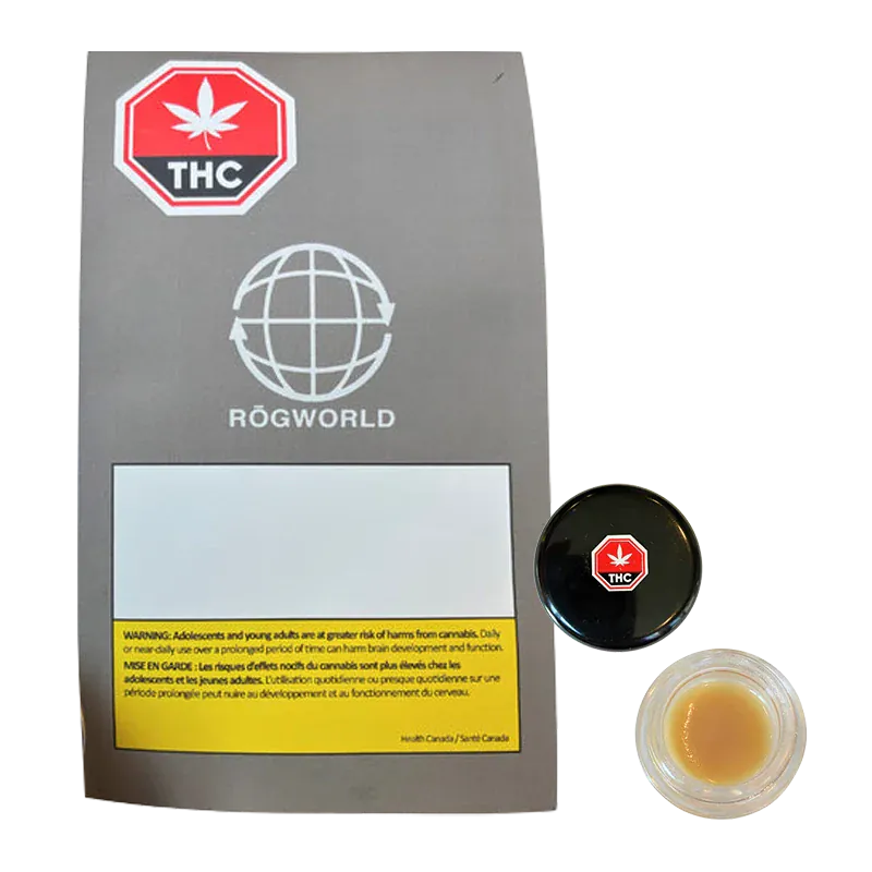 Top-down photo of a small jar of Strawberry OG Whipped Live Resin beside its gray Rögworld sleeve, jar lid showing a red THC octagon.