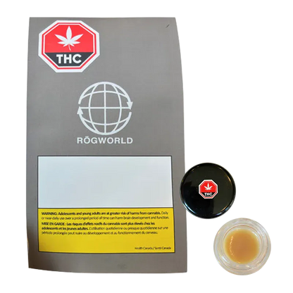 Top-down photo of a small jar of Strawberry OG Whipped Live Resin beside its gray Rögworld sleeve, jar lid showing a red THC octagon.