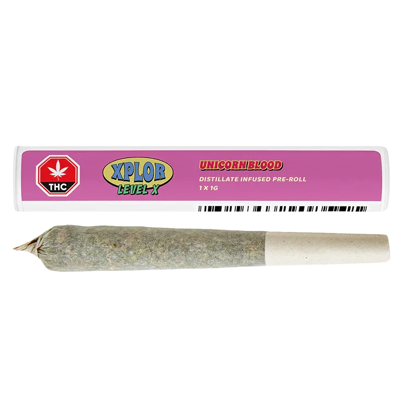 Close-up of a rolled pre-roll below its pink tube packaging labeled "Unicorn Blood Distillate Infused PR 1 x 1 g" and XPLOR branding.
