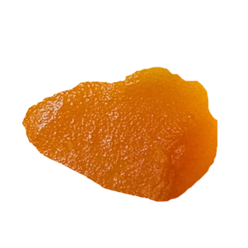 Close-up overhead view of a glossy amber shard of Blue Dream Live Resin against a white background.