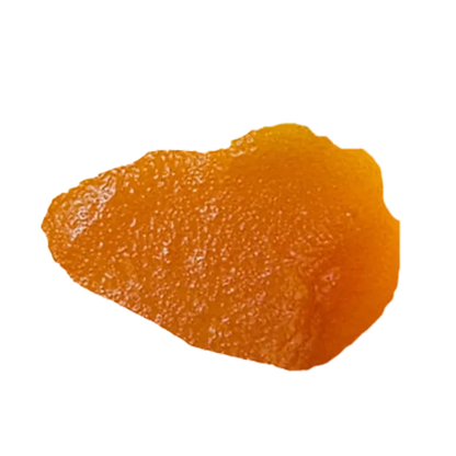 Close-up overhead view of a glossy amber shard of Blue Dream Live Resin against a white background.