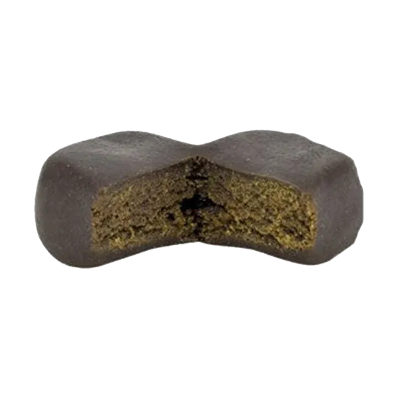 Close-up front view of a dark, X-shaped chew with a textured green interior — Kush Mints Classic Gummy Hash.