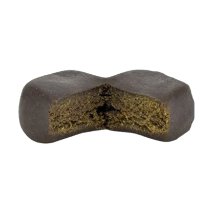Close-up front view of a dark, X-shaped chew with a textured green interior — Kush Mints Classic Gummy Hash.