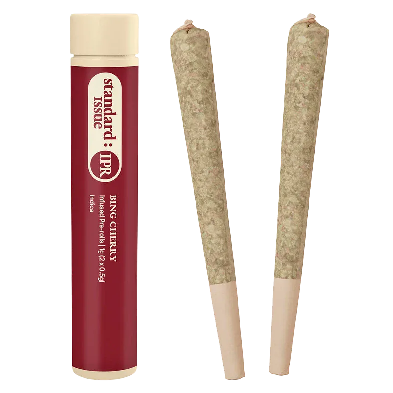 Studio-lit front view of the Bing Cherry Infused PR 2 x 0.5 g tube standing next to two rolled joints on a white background