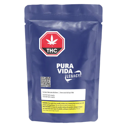 Front-facing photo of a blue pouch labeled Pura Vida Legacy Slap & Tickle Jumbo Slab Shatter with a red THC stop sign logo and QR code.