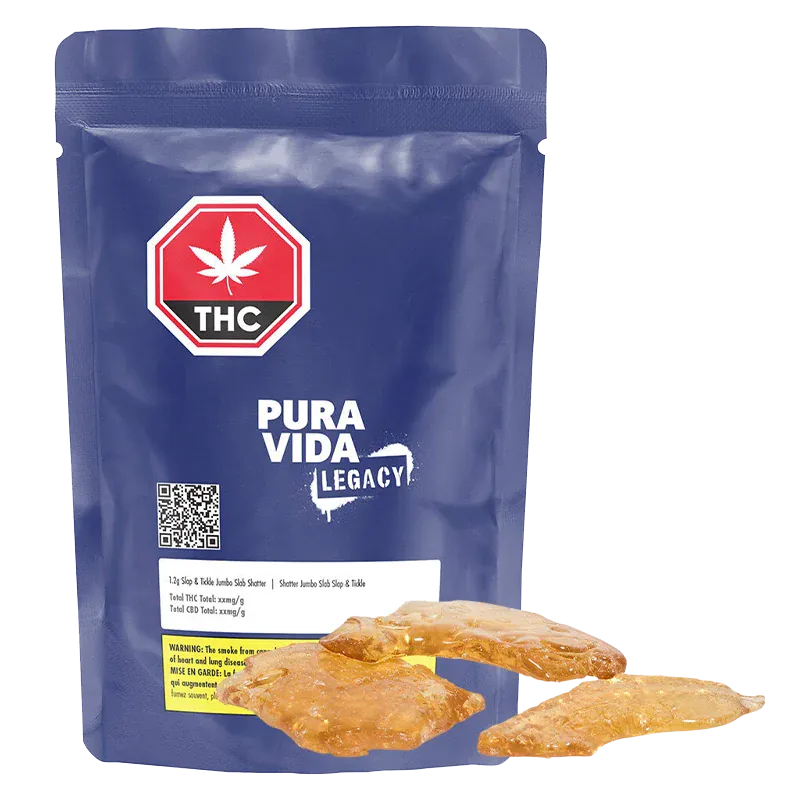 Front-facing view of a blue resealable pouch labeled Pura Vida Legacy with three amber slabs of Slap & Tickle Jumbo Slab Shatter arranged at its base